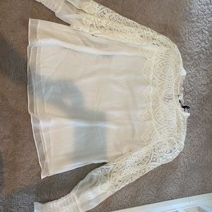 Beautiful white blouse with sheer sleeves.